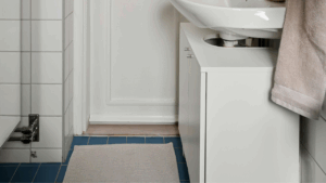 Non-slip mat in pastel-colored bathroom, ensuring elder safety near bathtub.
