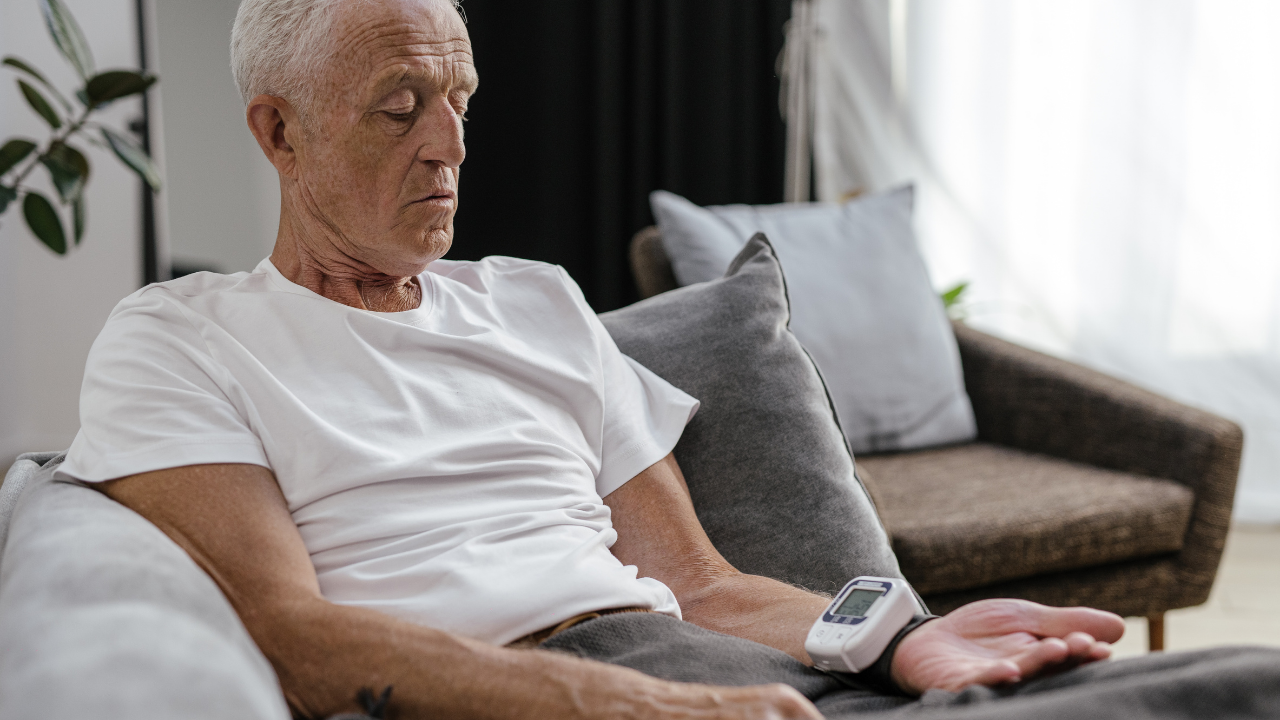 An old man checking his blood pressure